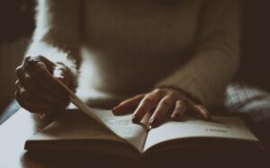 photo of person flipping through her Bible study lessons